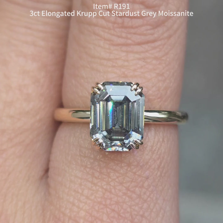 Elongated Krupp cut stardust grey color moissanite ring sparkling in sunlight video.