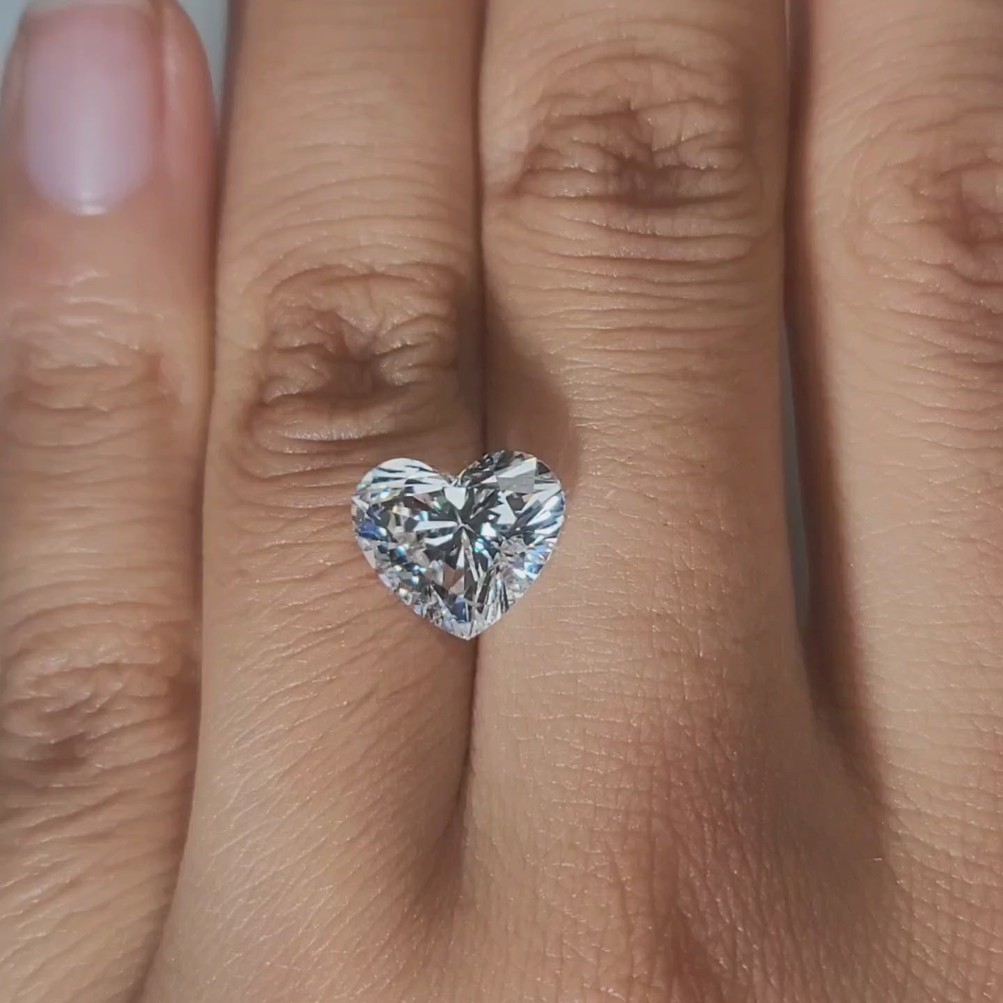 Hand-worn video showcasing heart shape in golden hour light