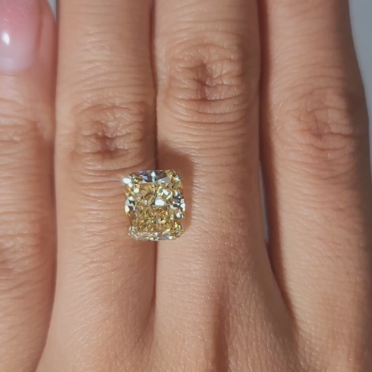 Close-up hand modeling showing diamond's size and sparkle