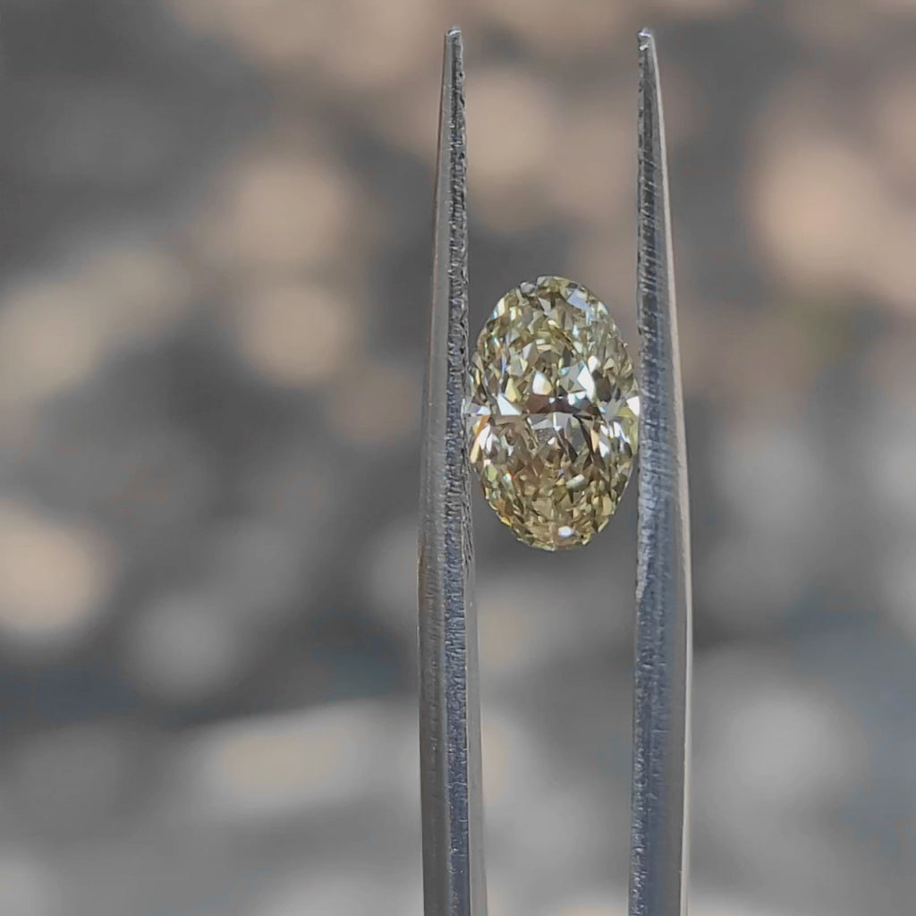 "Sunlight video showing 1.635ct oval cut fancy vivid yellow diamond's warm glow"