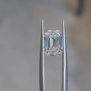 Outdoor video emphasizing 3.303ct emerald cut's near-colorless E grade and luster