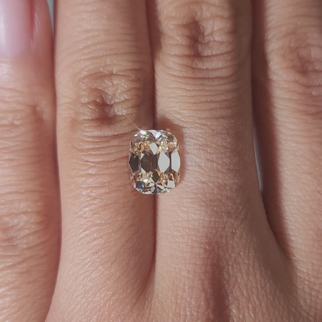 Romantic warmight video of 2.73ct orange cushion diamond on finger