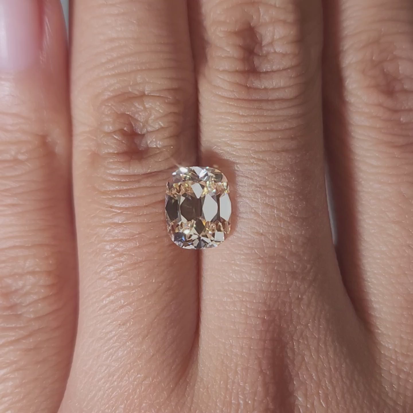 Romantic warmight video of 2.73ct orange cushion diamond on finger