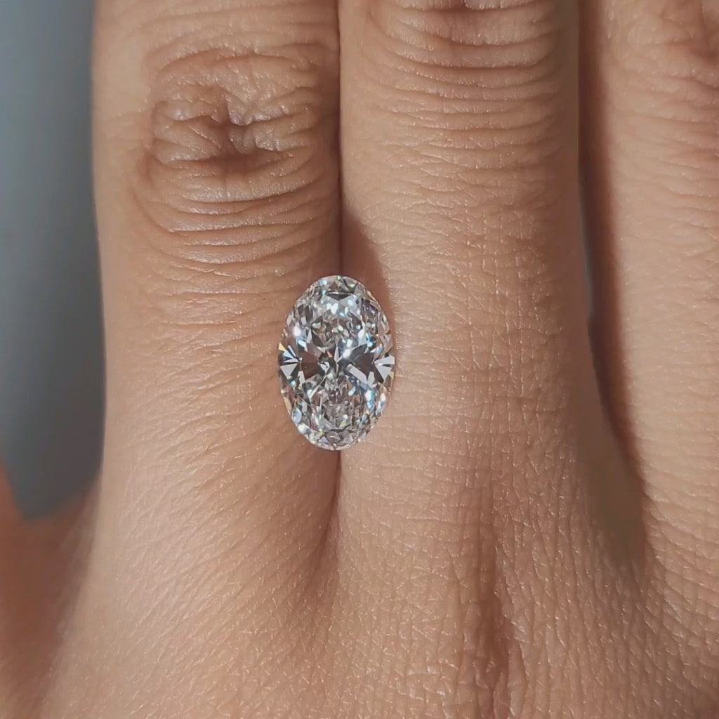 Close-up hand video of 2.02ct oval diamond in soft indoor lighting