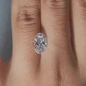 Close-up hand video of 2.02ct oval diamond in soft indoor lighting