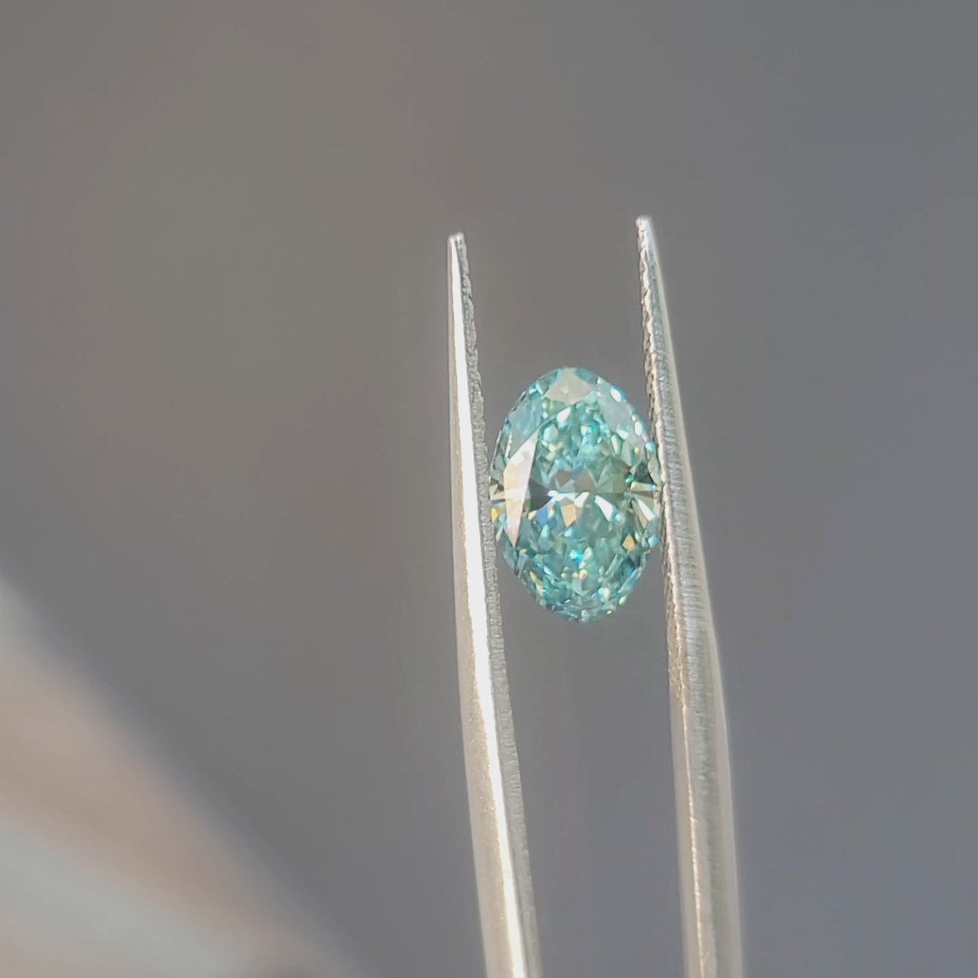 Sunlight video showing 2.03ct oval brilliant cut lab diamond's fancy vivid greenish blue sparkle