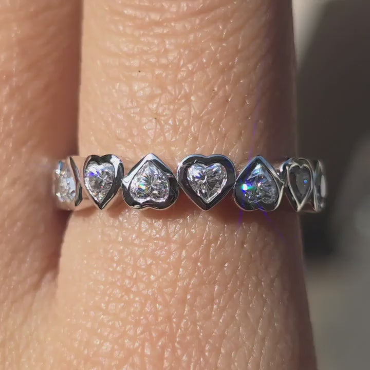 DovEggs heart moissanite wedding band sparkling in sunlight