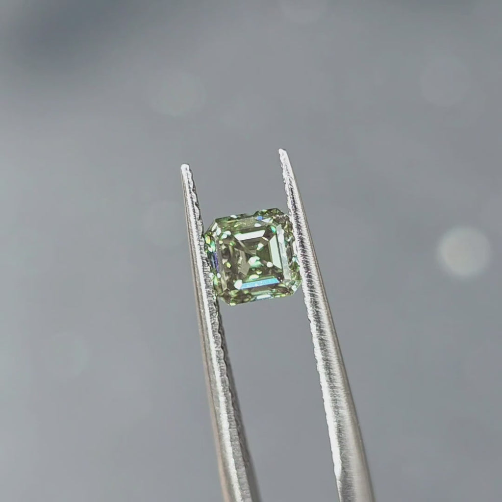 1.03ct asscher cut fancy vivid green VVS1 lab diamond showing intense color in outdoor sunlight.