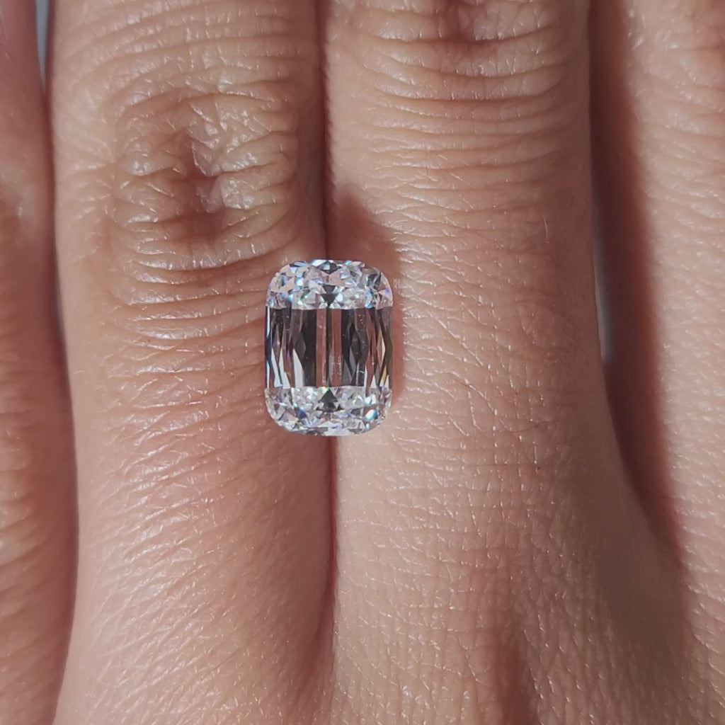 "Hand-modeled video of 2.506ct cushion diamond in warm indoor lighting"