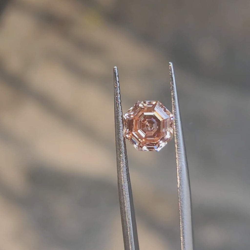 2.56ct modified octagon fancy vivid pink diamond in sunlight, showcasing rare color saturation
