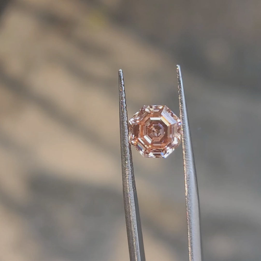 2.56ct modified octagon fancy vivid pink diamond in sunlight, showcasing rare color saturation