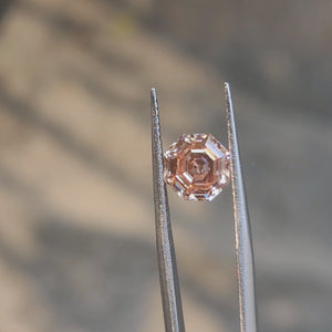 2.56ct modified octagon fancy vivid pink diamond in sunlight, showcasing rare color saturation