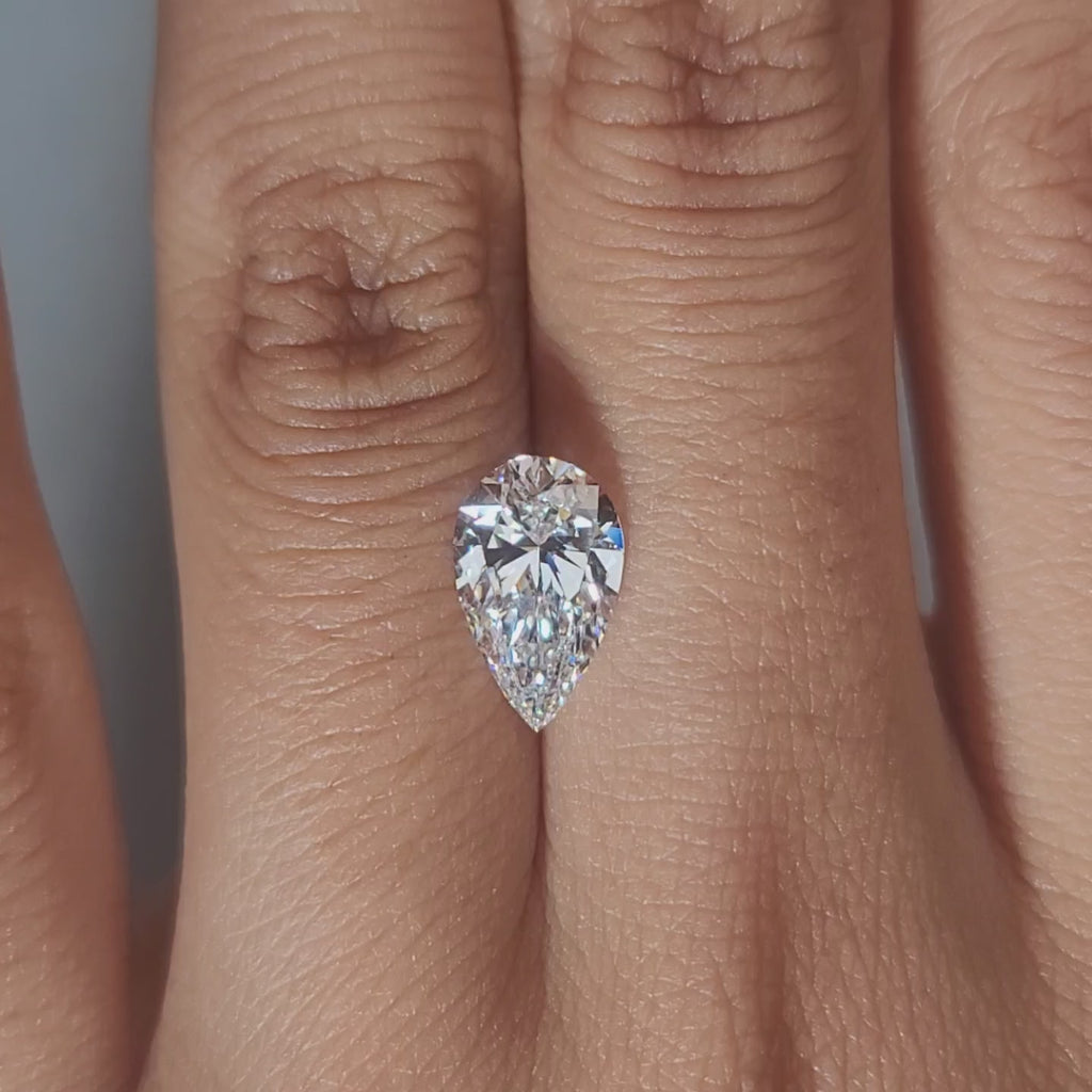 Hand-worn video showing 1.79ct pear diamond in warm interior lighting