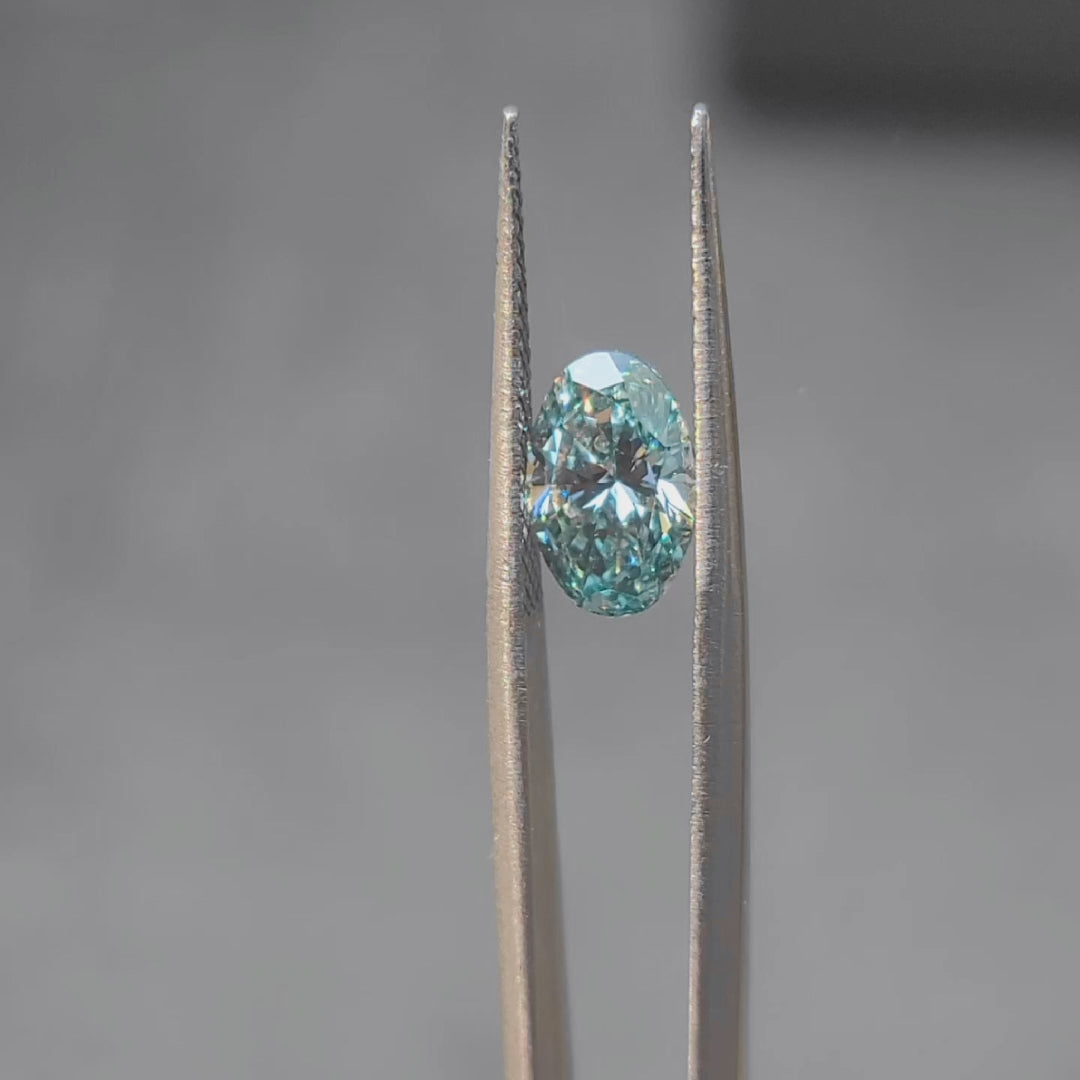 2.002ct oval fancy vivid blue diamond in sunlight, displaying intense color