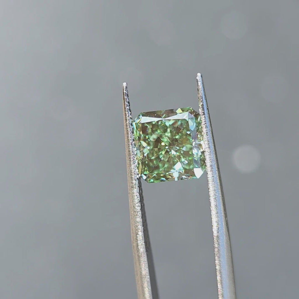 3.09ct radiant cut fancy vivid green VVS2 lab diamond sparkling in outdoor sunlight.