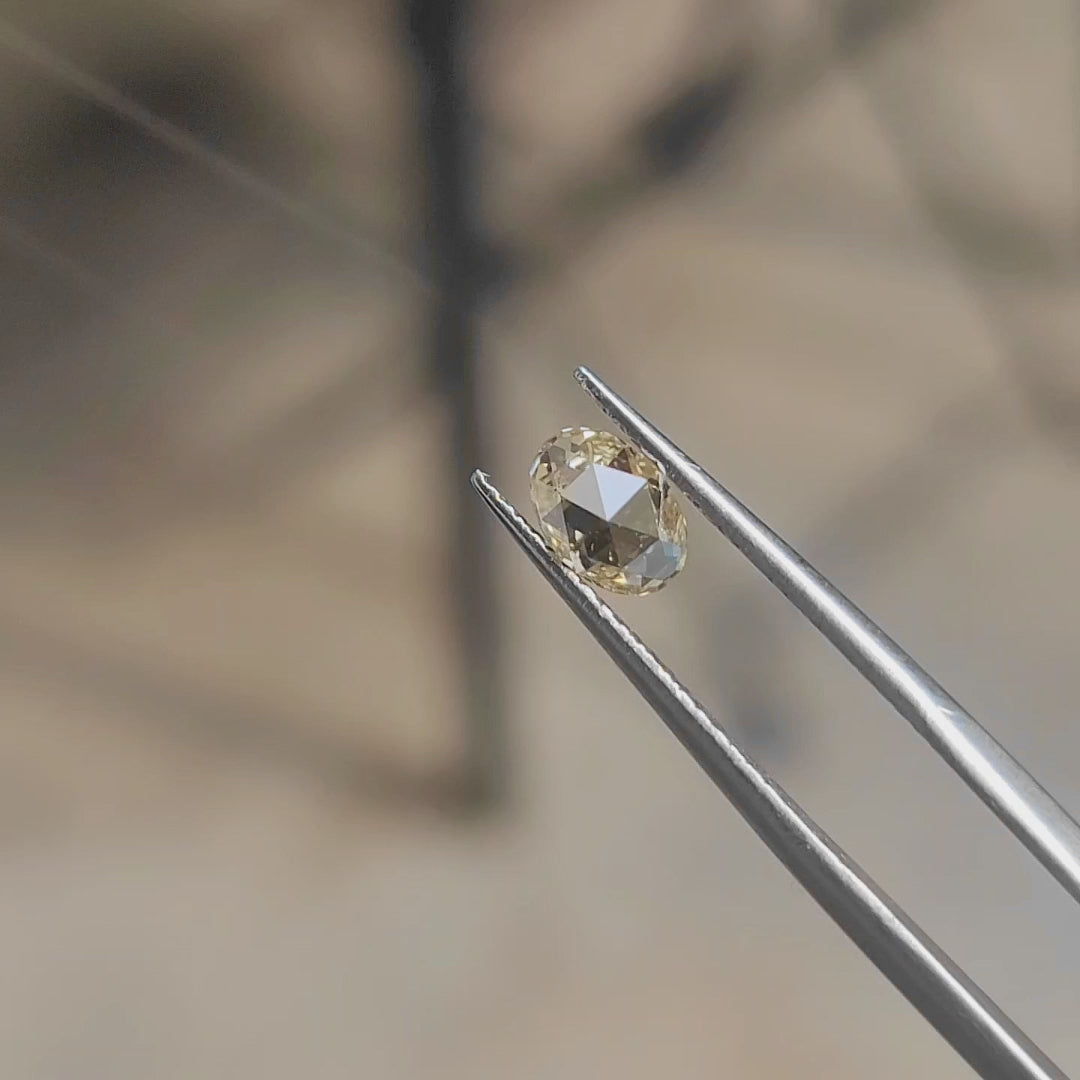 "Sunlight video highlighting 0.77ct oval rose cut's buttery yellow hue and satin finish"