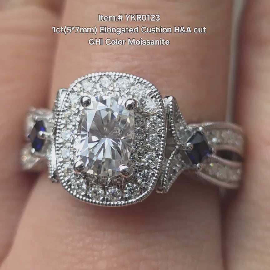 DovEggs Elongated cushion H&A cut engagement moissanite ring sparkling in sunlight video.