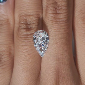 Finger-modeled video of 2.927ct pear diamond in cozy indoor lighting
