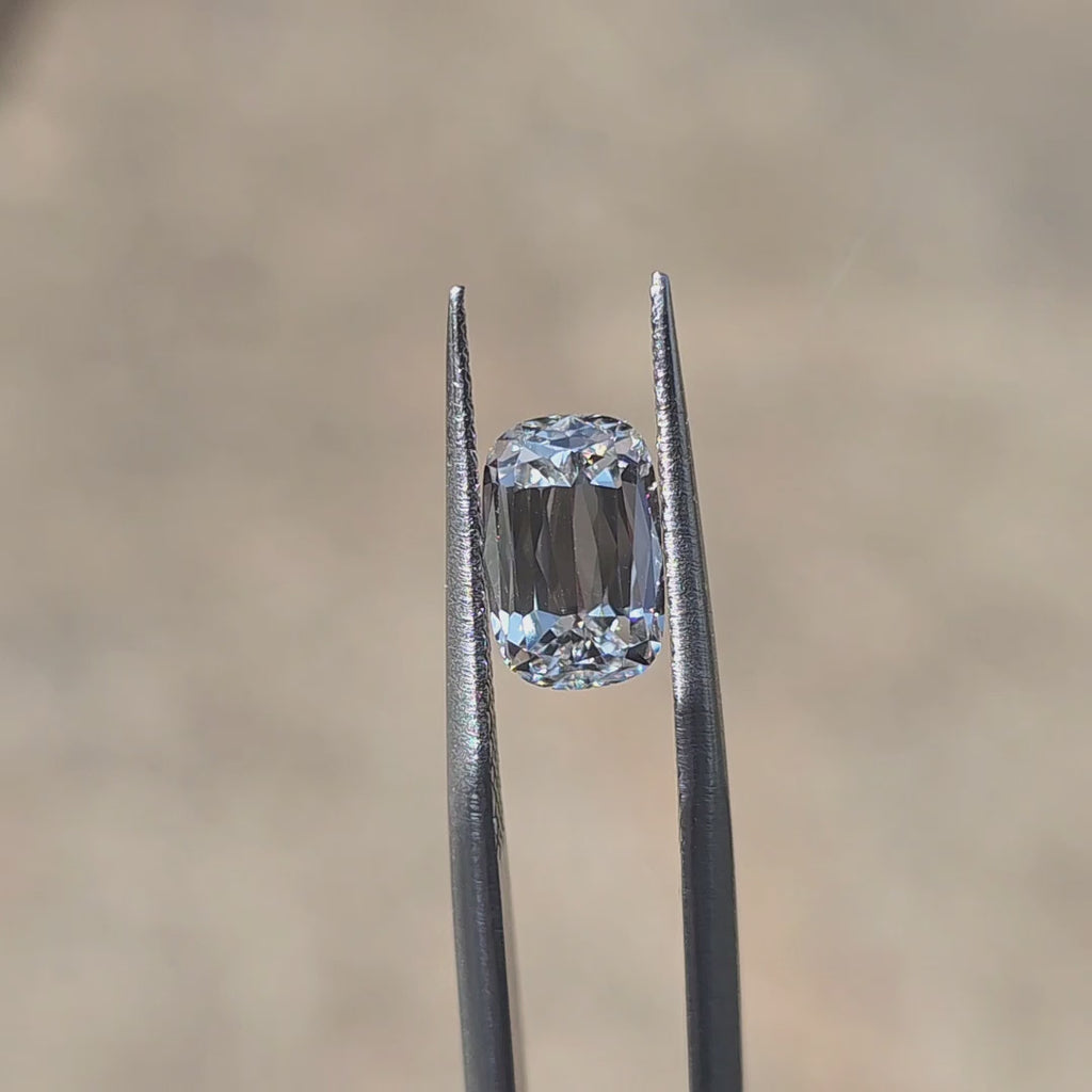 Lab diamond 2.54ct modified elongated cushion D color VVS1 by DovEggs displaying elegant elongated sparkle in outdoor sunlight.