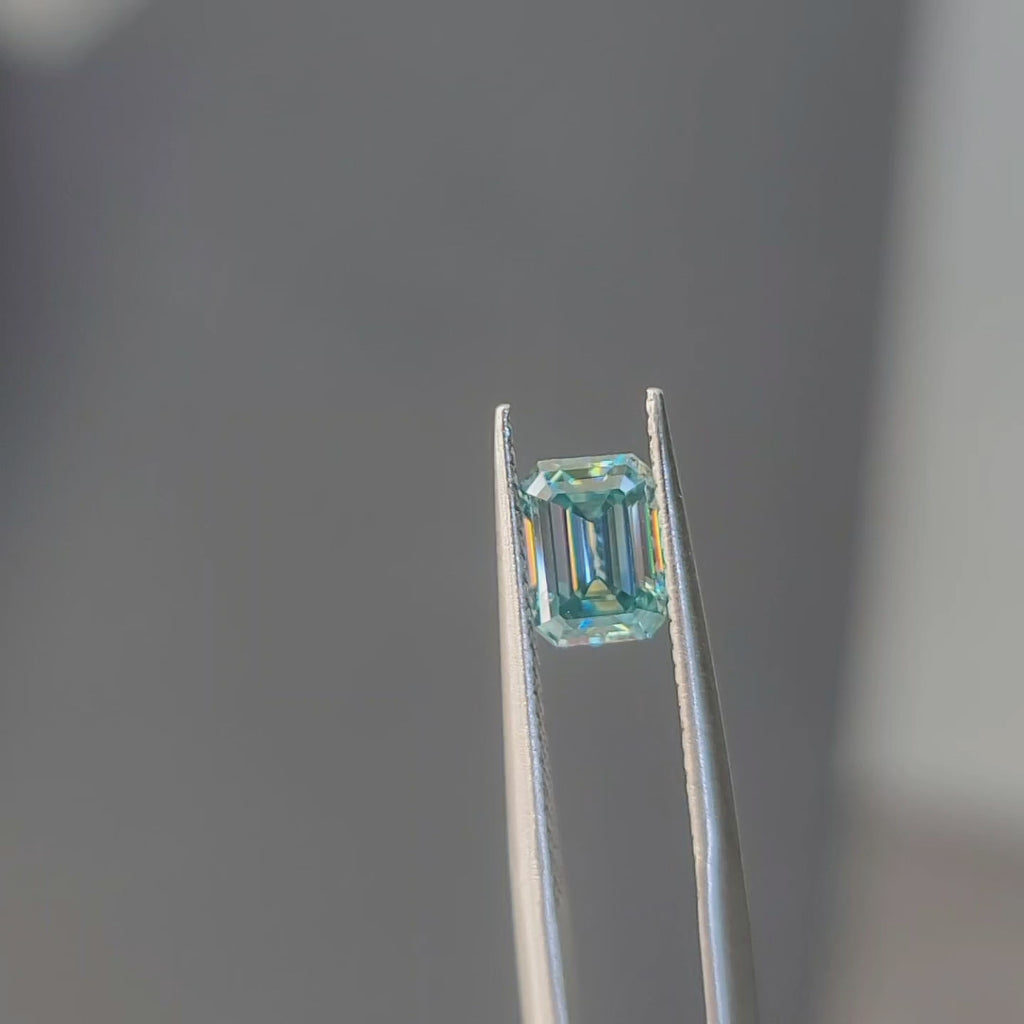 DovEggs Emerald aurora teal accident color moissanite in sunlight