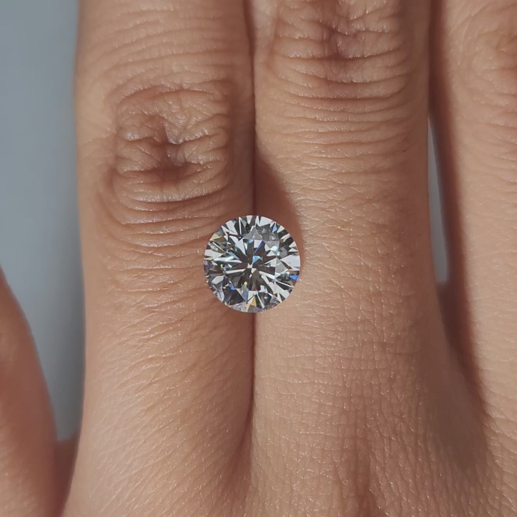 Close-up slow motion of F color VVS2 diamond's sparkle in warm lighting