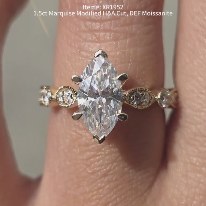 DovEggs Modified H&A cut marquise moissanite engagement ring sparkling in sunlight video.