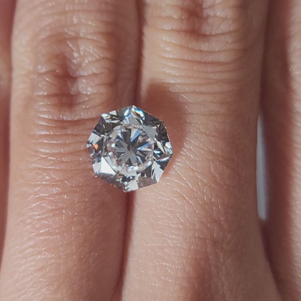 "Hand-modeled video of 3.496ct octagon diamond in warm indoor lighting"
