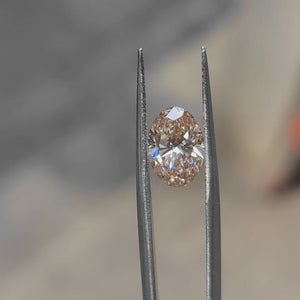 2.36ct Oval lab diamond’s vibrant orange glow under natural sunlight