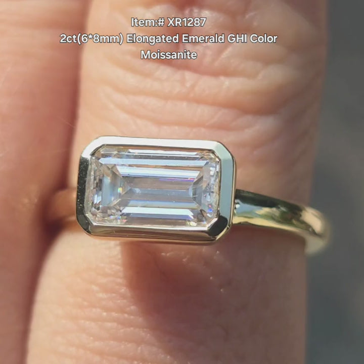 DovEggs 2ct elongated emerald moissanite ring with bezel setting under sunlight video