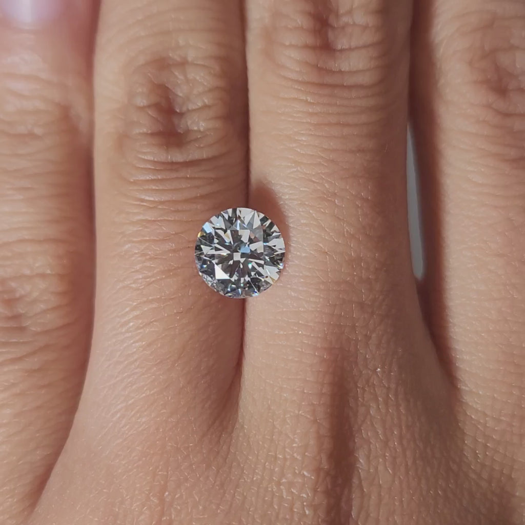 Close-up hand video of 2.03ct ideal cut diamond in warm lighting, perfect for solitaire rings