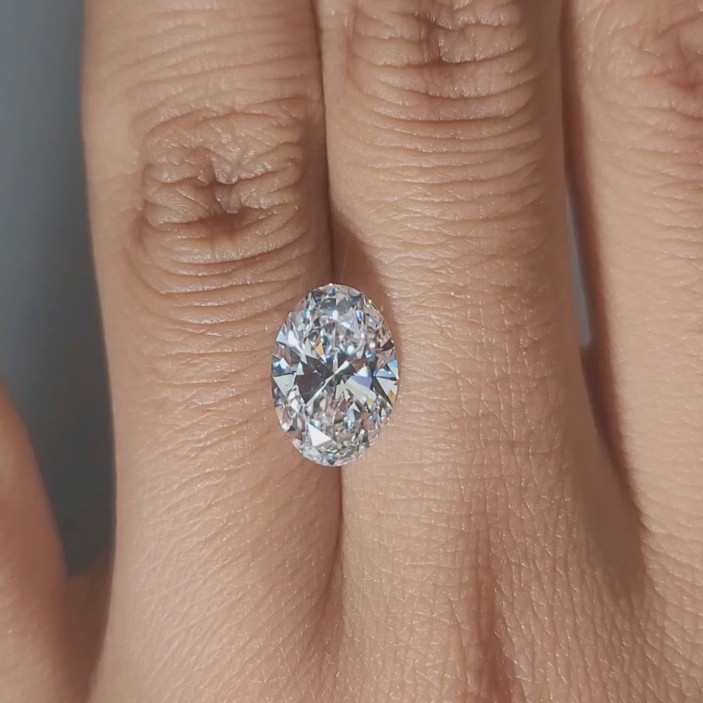 Hand-worn video showing 2.61ct oval diamond in warm home lighting