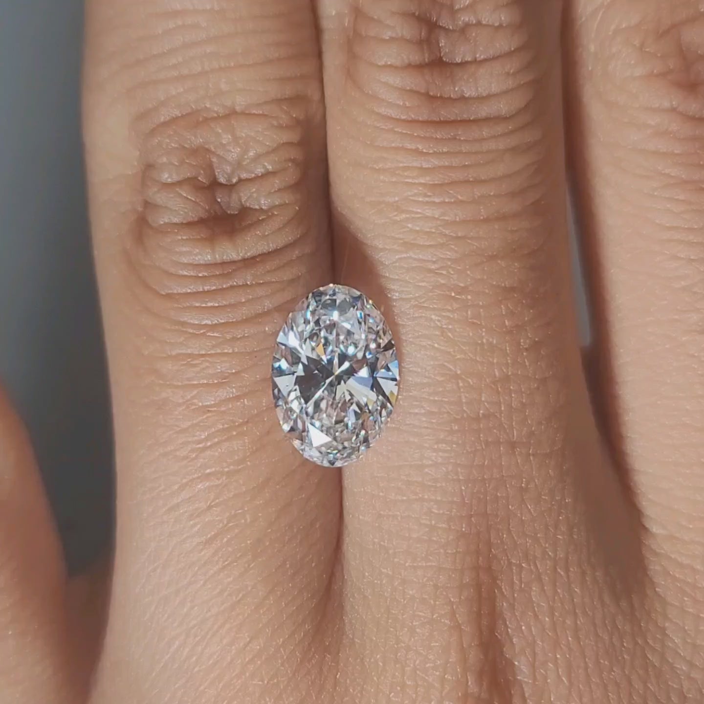 Hand-worn video showing 2.61ct oval diamond in warm home lighting