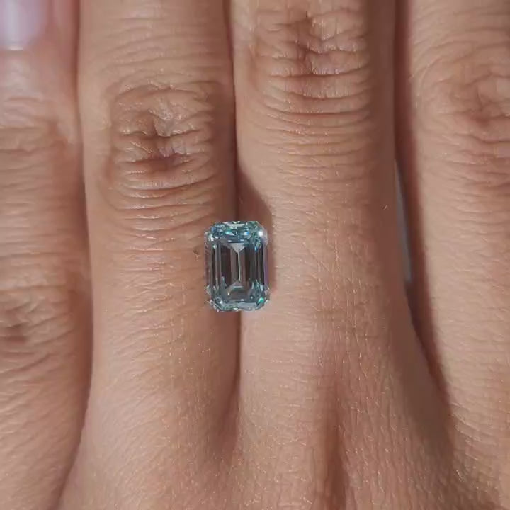 Finger-worn video of 2.064ct blue emerald diamond in ambient indoor light