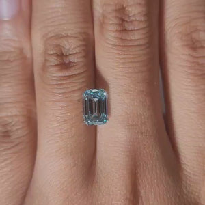 Finger-worn video of 2.064ct blue emerald diamond in ambient indoor light