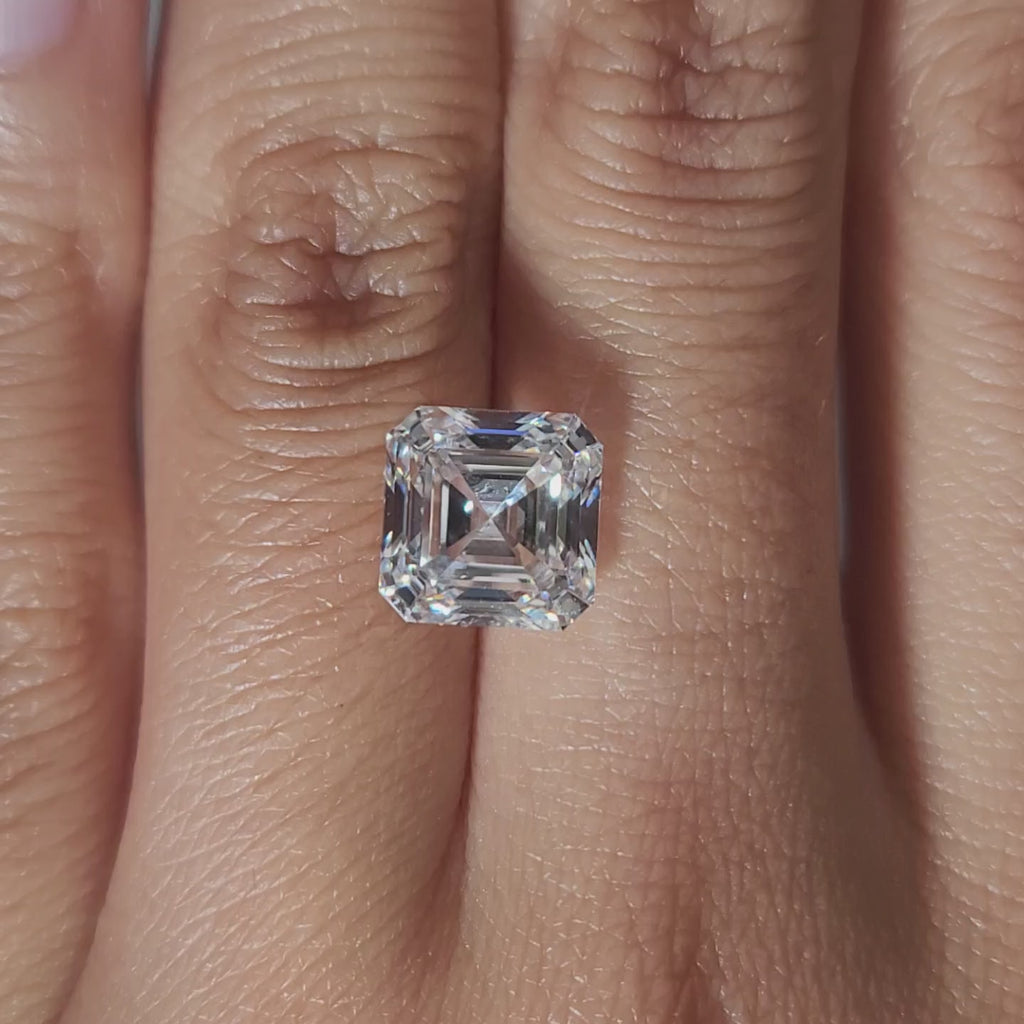 "Hand-modeled video of 4.103ct asscher diamond in warm indoor lighting"