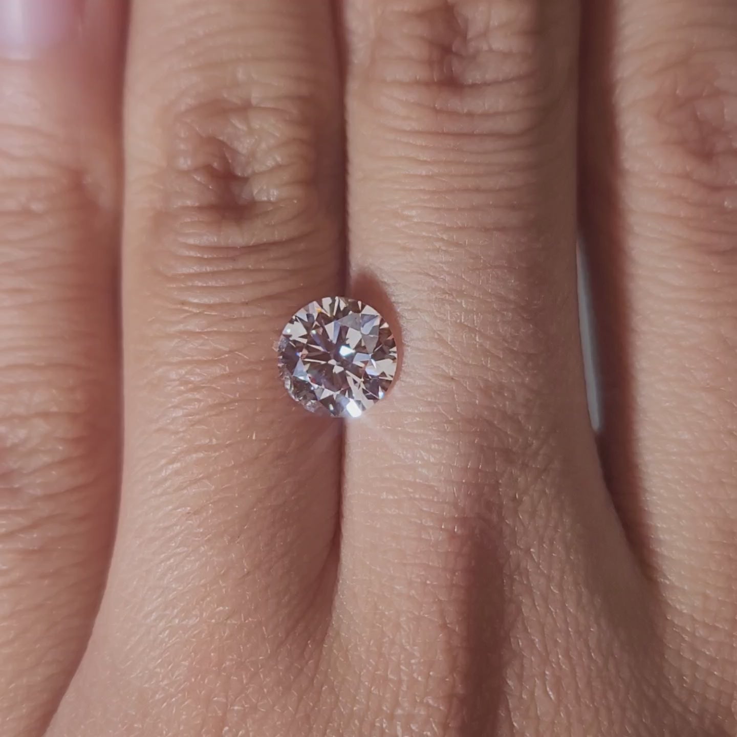 1.59ct Round pink diamond in warm ambient lighting