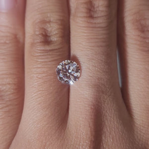 1.59ct Round pink diamond in warm ambient lighting