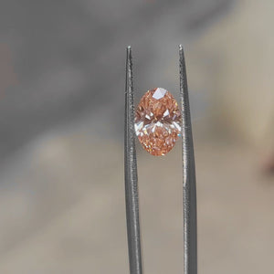 1.71ct Oval pink diamond shimmering under bright outdoor light