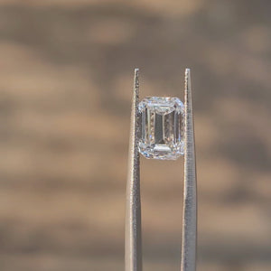 2.54ct emerald cut D color diamond video showing icy white appearance outdoors