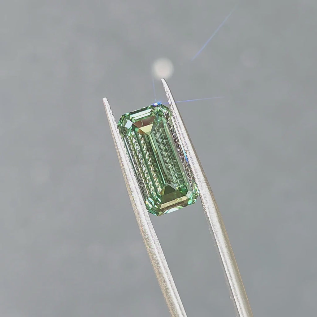 6.04ct emerald cut fancy vivid green VVS1 lab diamond sparkling under outdoor sunlight.