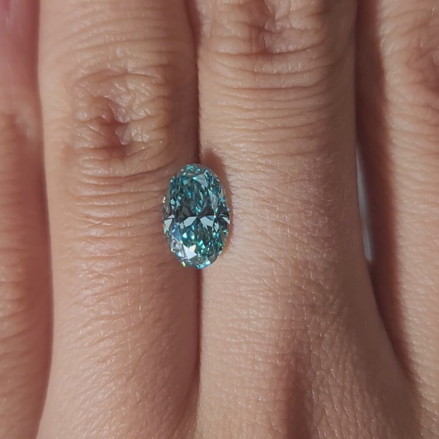 Hand-worn video of 1.539ct blue diamond in warm lighting