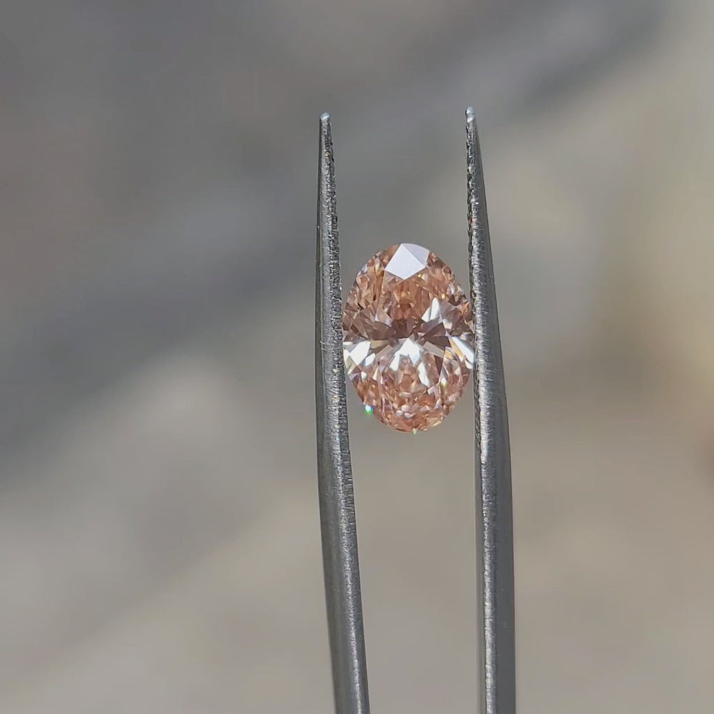 2.54ct Oval lab diamond’s vivid pink sparkle enhanced by sunlight
