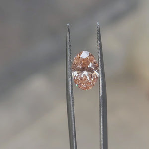 2.54ct Oval lab diamond’s vivid pink sparkle enhanced by sunlight