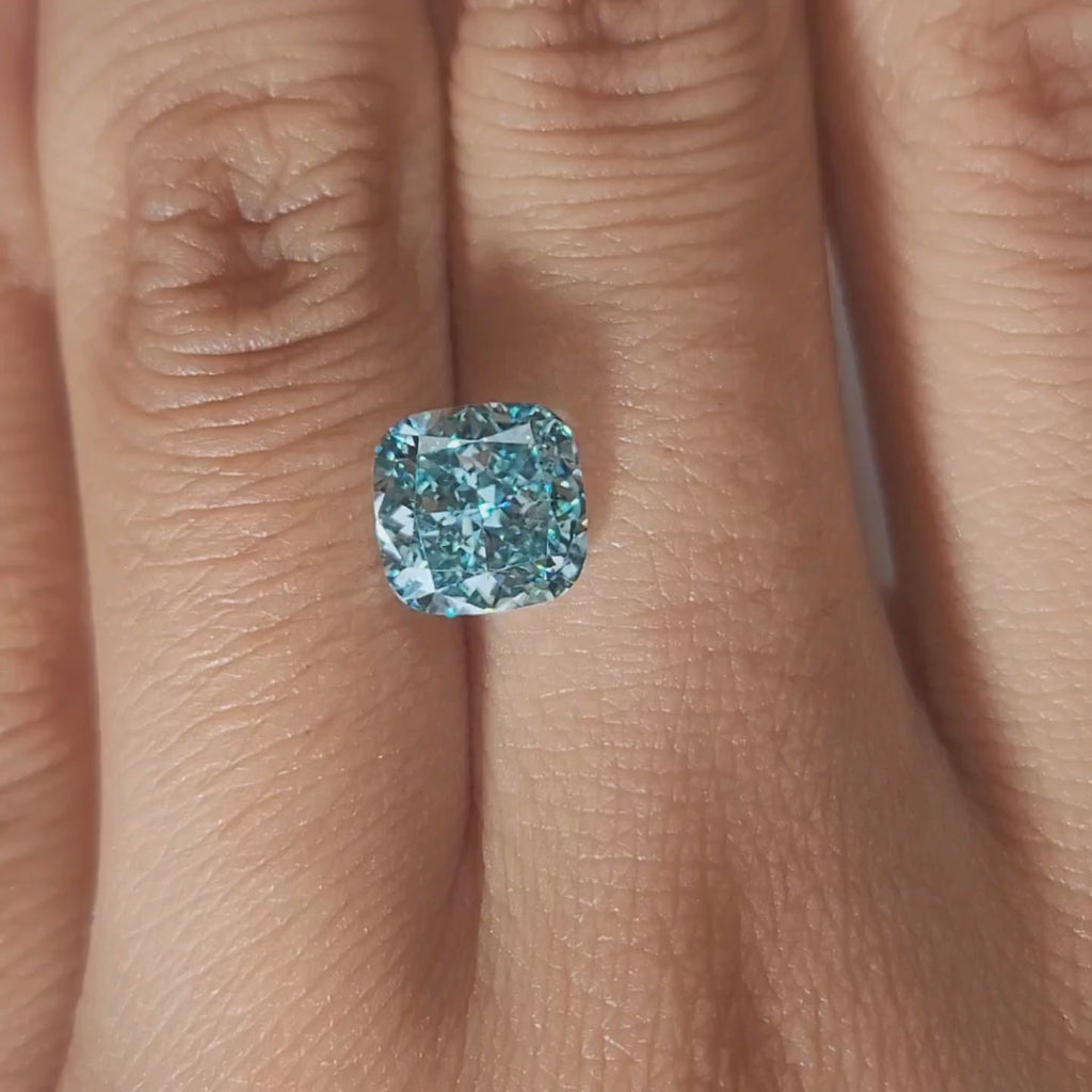 Ring-setting video of 2.362ct blue cushion diamond in soft indoor light