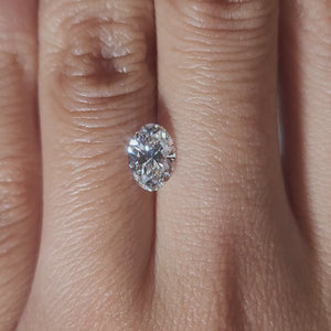 "Hand-modeled video of 1.02ct oval diamond in warm indoor lighting"