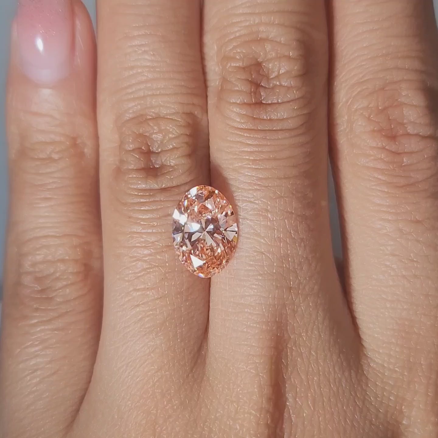 3.17ct Oval vivid pink diamond showcased in soft candlelight