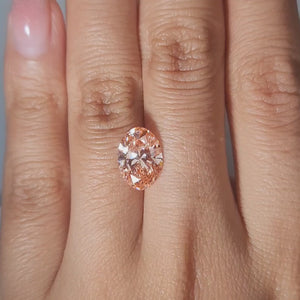 3.17ct Oval vivid pink diamond showcased in soft candlelight