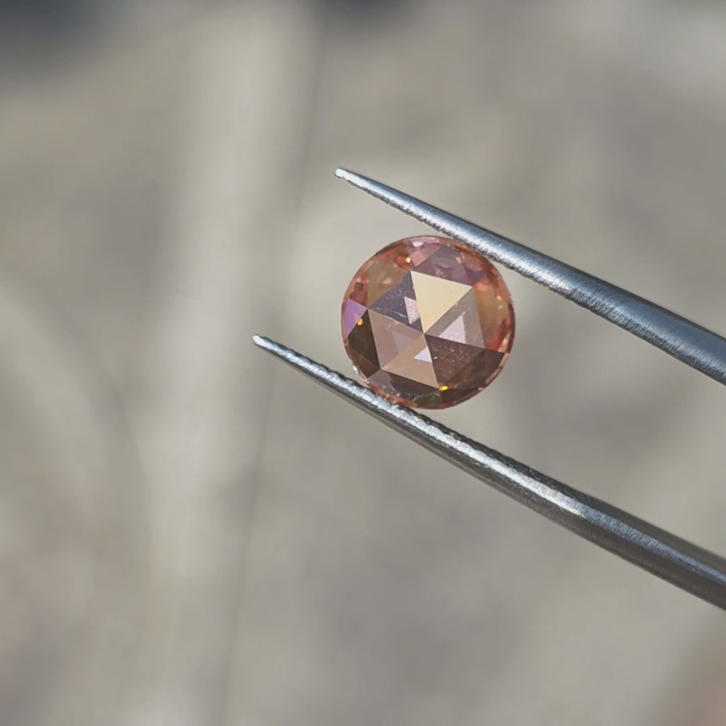 2.43ct round rose cut fancy vivid pink VVS2 lab diamond showing romantic pink hue in outdoor sunlight.