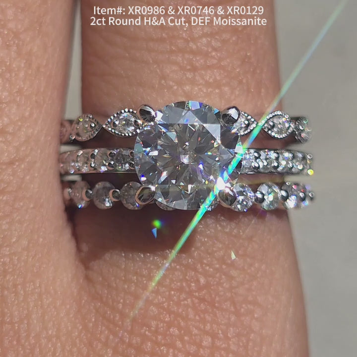 DovEggs Round H&A cut moissanite engagement ring sparkling in sunlight video.