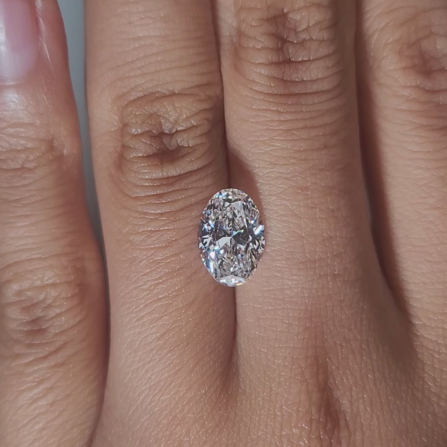 Hand-modeled video of 2.170ct oval diamond in warm indoor lighting